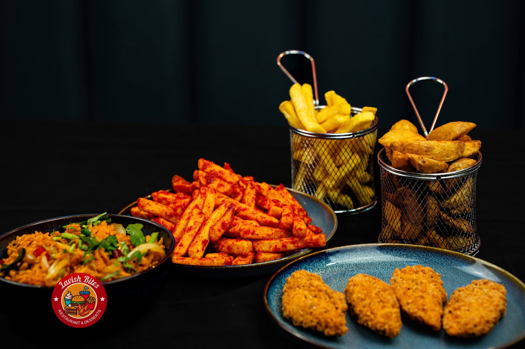 A spread of loaded peri peri fries, chips, wedges and crispy chicken bites at Lavish Bites